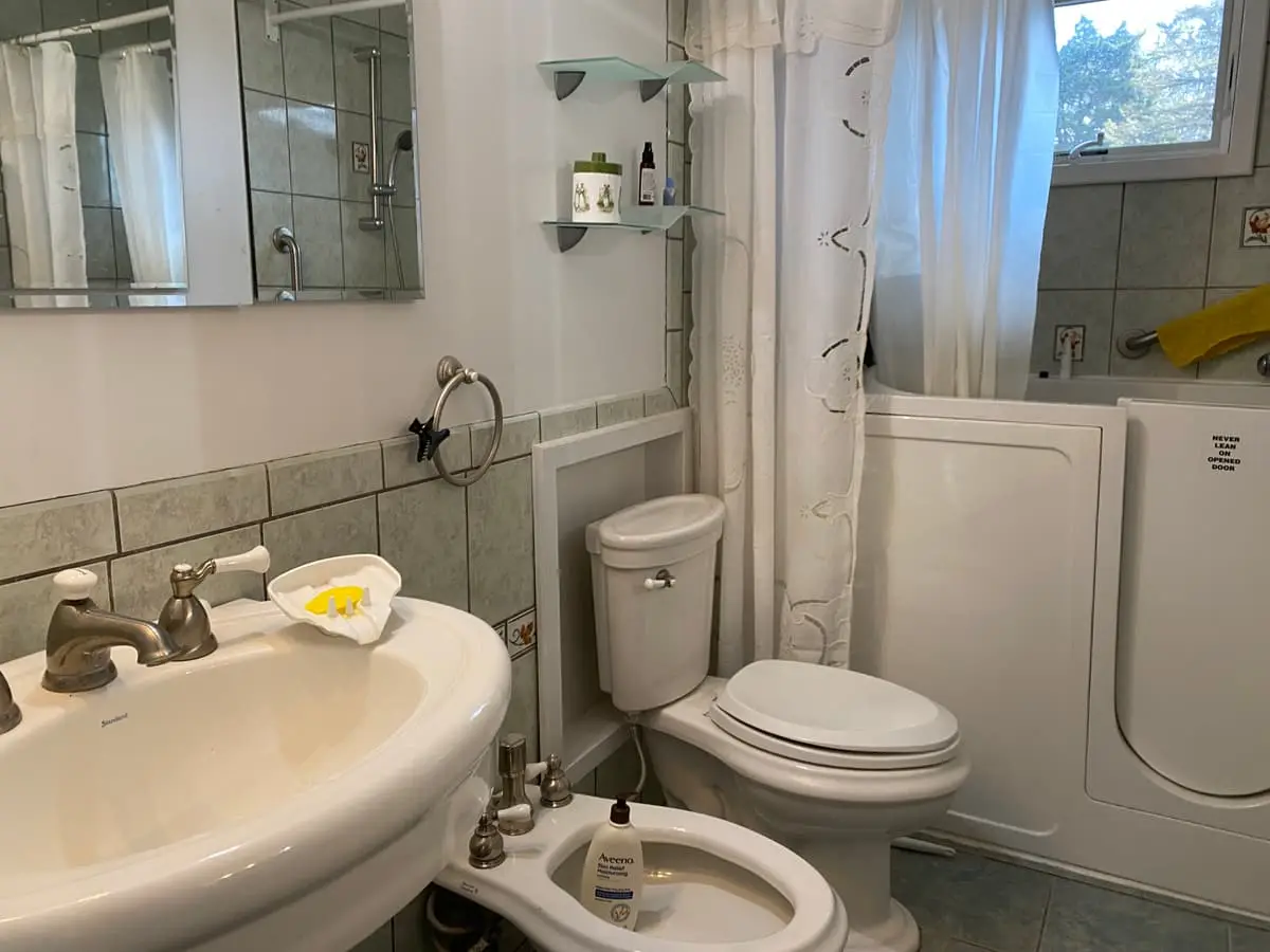 Downsizing or retiring in Coram: bathroom with a walk-in tub, bidet and pedestal sink