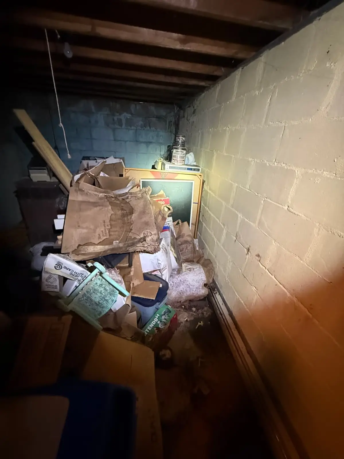 Dealing with squatters or holdover tenants in Coram: cinder block storage room heaped with boxes and junk