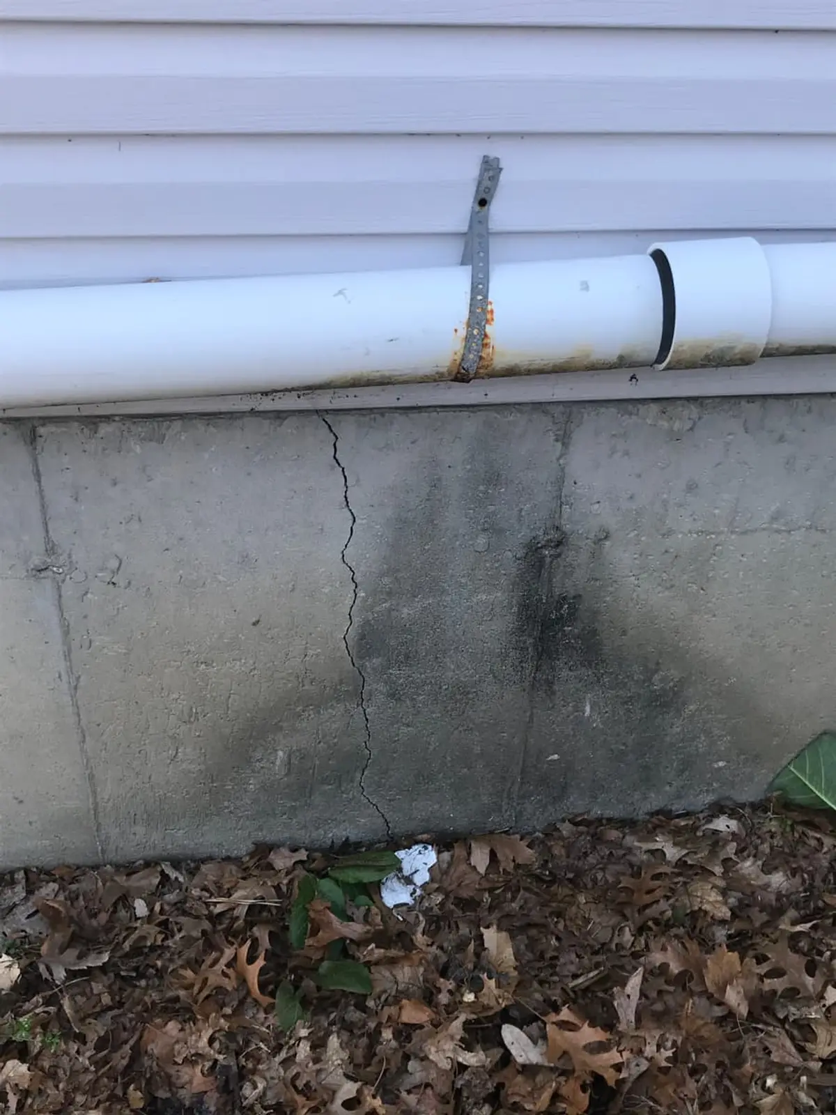 Selling a house as-is in Coram: crack running down a concrete foundation wall