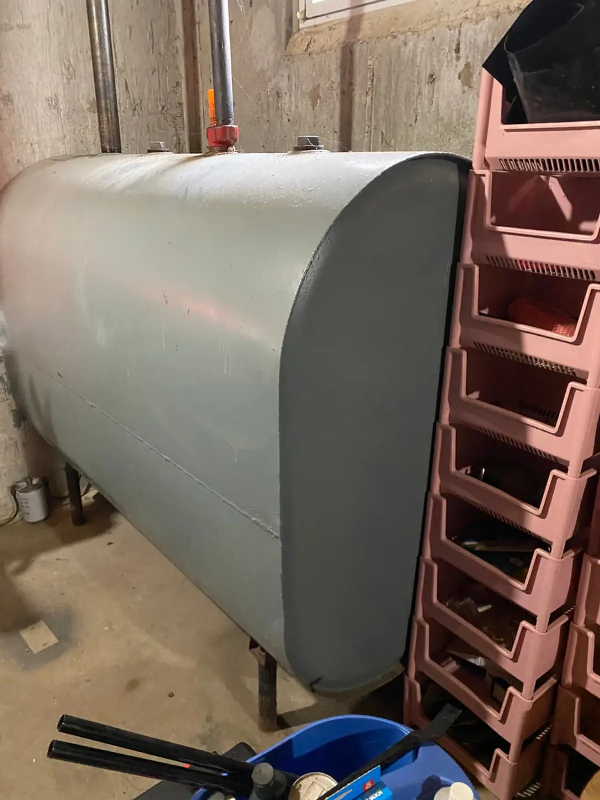 Selling a house with an oil tank in Coram: gray oil tank sitting against the basement wall